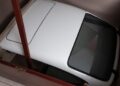 A Porsche 959 Speedster is parked indoors in a narrow, enclosed space in Milan, partially obstructed by wooden beams—an exclusive moment reminiscent of an RM Sotheby's showcase.