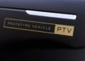 Close-up of a black car door featuring a chrome handle and a gold label that reads "PROTOTYPE VEHICLE PTV," seen during cold weather testing of the Range Rover Electric in Sweden.