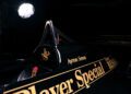 Close-up of a black race car with "Ayrton Senna" and "John Player Special" in gold lettering.