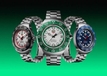 Three TAG Heuer metallic wristwatches with round faces and chain-link bands are displayed against a green gradient background. Each watch, reminiscent of the vibrant hues found in motorsport, features unique accent colors: red, green, and blue.