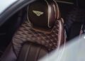 Close-up of a brown Heritage Leather car seat with diamond stitching and a Bentley logo embroidered on the headrest, showcasing this luxurious Interior Option.