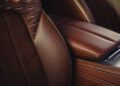 Close-up of a Bentley Heritage Leather Interior, showcasing brown perforated leather car seats and a matching leather-covered center console.