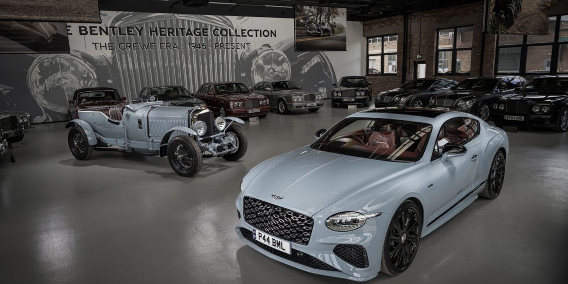 A modern Bentley coupe featuring Heritage Leather as an interior option stands beside a vintage Bentley, both displayed in a showroom with other classic vehicles and Bentley Heritage Collection signage in the background.