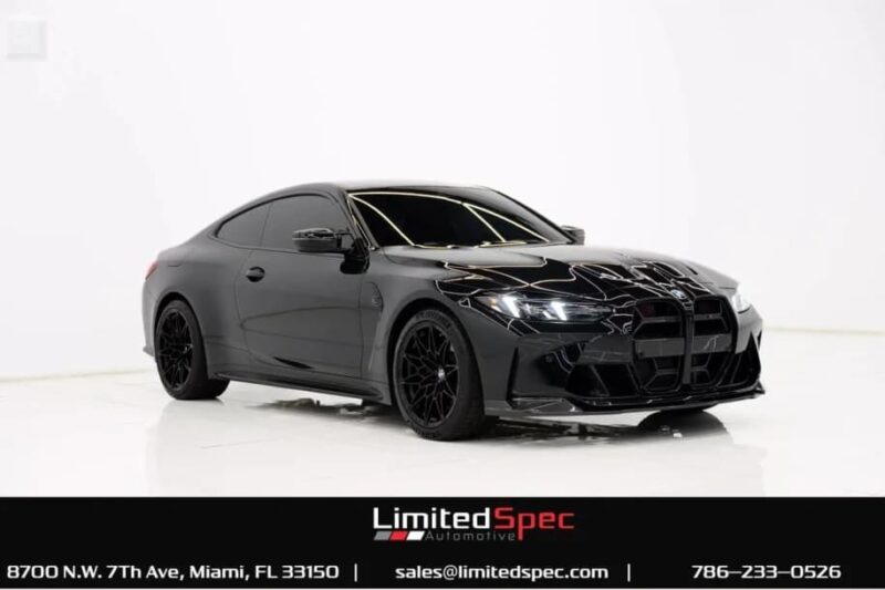 A black luxury sports coupe car for sale is displayed in a white studio setting, with contact information for LimitedSpec Automotive at the bottom.