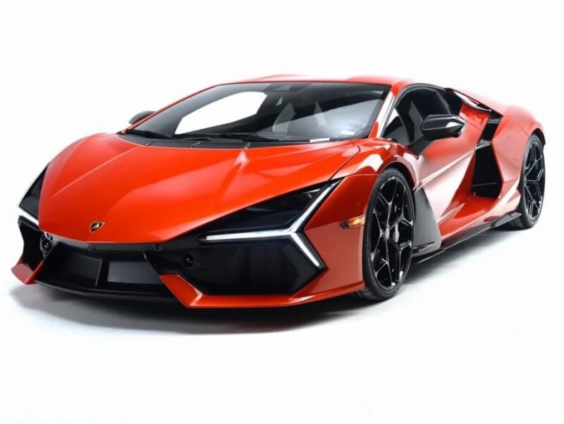 A red Lamborghini luxury car is shown in a studio setting, viewed from the front left angle against a white background.