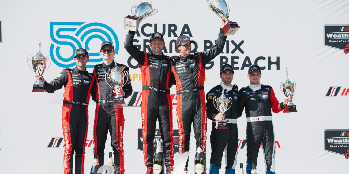 Race car drivers on the podium celebrate a thrilling one-two finish, clutching their trophies at the Acura Grand Prix of Long Beach while posing in front of a Porsche-branded backdrop.