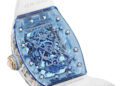 A Richard Mille RM 75-01 from the Sapphire Collection features a transparent blue case, intricate visible mechanics, and a white strap, elegantly displayed on a white background.