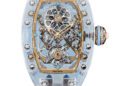A Richard Mille Sapphire Collection RM 75-01 watch featuring a transparent case, visible intricate mechanical movement, a white strap, and striking blue accents on the crown.