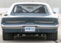 Rear view of a classic 1969 Charger muscle car with wide tires, an Ontario license plate reading "VRYN1CE," and packing a powerful Hellephant 1,000-HP engine, parked on a paved surface.
