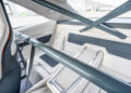The image shows the rear interior of a 1969 Charger featuring a visible roll cage and light-colored upholstery with geometric patterns—an impressive detail for this Hellephant-powered, 1,000-HP beast.
