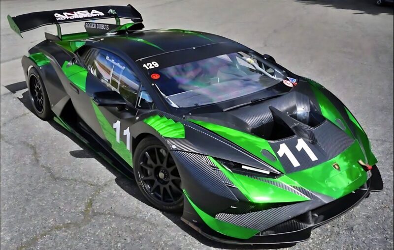 A green and black Lamborghini race car with the number 11 on the hood and sides, parked on asphalt—an enticing option for those seeking the best supercars under $200k.