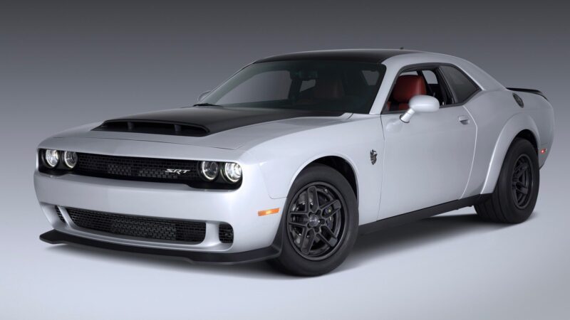 A white 2023 Dodge Challenger SRT Demon 170 muscle car with a black hood scoop, black wheels, and red interior, photographed in a studio—a crown jewel no MOPAR collector can ignore.
