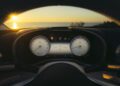Car dashboard with analog speedometer and tachometer, digital display in the center, photographed at sunset with the sun visible through the windshield—a glimpse of luxury you can expect from the 2026 Mercedes-Maybach SL 680 at US dealers.