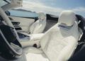 Interior of the 2026 Mercedes-Maybach SL 680 convertible with white leather seats, Maybach logo on headrests, and breathtaking ocean and mountain views— arriving at US dealers in 2025.