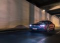 A red Mercedes-Maybach SL 680 with headlights on speeds through a tunnel at night; motion blur suggests high speed, teasing what US dealers may expect for the 2026 Mercedes-Maybach lineup.
