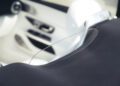 Close-up of a car's rear seat and headrest area, featuring a transparent partition and a modern, white interior design—showcasing the luxurious details expected in the upcoming 2026 Mercedes-Maybach SL 680 arriving at US dealers.
