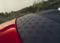 Close-up of a 2026 Mercedes-Maybach SL 680’s rear deck, its matte black surface adorned with a repeating Maybach logo pattern, set against a blurred natural background. Now arriving at US Dealers.