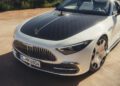 A white Mercedes-Maybach SL 680 convertible with a patterned black hood is parked on a sunlit pavement, hinting at the luxury soon arriving at US dealers in the 2026 Mercedes-Maybach lineup.