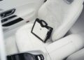 A black and white handbag with a chain strap rests on the front passenger seat of a 2026 Mercedes-Maybach SL 680, showcasing its elegant patterned leather upholstery.