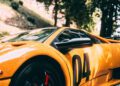 Close-up of the side of a yellow Lamborghini sports car with the number 04 displayed on the door, parked outdoors near trees—a true classic among race cars.