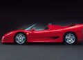 A red Ferrari F50 convertible sports car is seen from the side against a black background, celebrating its 30th Anniversary on the Legacy Tour.