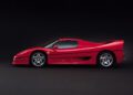 Side view of a red Ferrari F50 sports car, photographed against a black background, celebrating the 30th Anniversary Legacy Tour.