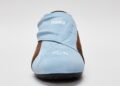 A light blue and brown suede STARLINE Sneaker slip-on shown from the front, with white embroidered "RSRV" text and small graphics on top, blending Alpinestars RSRV style with subtle F1 DNA elements.
