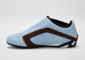 A light blue STARLINE Sneaker with brown accents and a black sole, shown in profile against a plain white background, channels subtle F1 DNA for a sleek and sporty vibe.