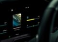 A car dashboard display shows music playing, driving mode set to Sport, temperature at 23°C, and available range of 200 miles at 12:50 AM—featuring the latest tech as Aston Martin becomes first automaker to debut Apple CarPlay Ultra.