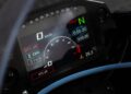 Close-up of a Carbon-Clad Concept BMW Motorrad digital dashboard, showcasing next-generation RR features like speedometer, gear position, riding mode indicators, and lap timer information.