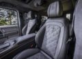 The image shows the front seats and interior of a luxury vehicle with quilted leather upholstery and branded BRABUS headrests, highlighting the refined craftsmanship typical of a G 63.