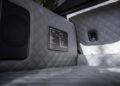 Diamond-stitched grey car interior with a speaker, a specification plaque, and a seat anchor visible on the side panel, showcasing the premium craftsmanship of the BRABUS G 63.