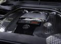 Close-up of a BRABUS 800 engine cover featuring carbon fiber detailing and visible branding under the hood of a G 63 XL 800 Off-Roader.