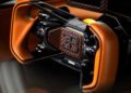 Close-up of a Bugatti Bolide steering wheel featuring brown leather, carbon fiber accents, and labeled control buttons—luxury design for a $4.7Million masterpiece.
