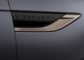 Close-up of a vehicle’s side vent with the word “Discovery” embossed on it, set against a matte grey body panel, celebrating Land Rover Marks 35 Years Of Discovery With Gemini And Tempest Special Editions.