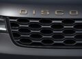 Close-up view of the front grille and partial headlight of a car, with "DISCOV" lettering visible above the grille, marking Land Rover's 35 years of Discovery with Gemini and Tempest Special Editions.