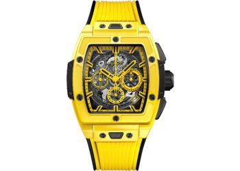 Yellow Hublot wristwatch with a skeleton dial, black accents, visible gears, and a yellow rubber strap. The rectangular case with exposed screws showcases the bold design found in today’s best luxury watches.