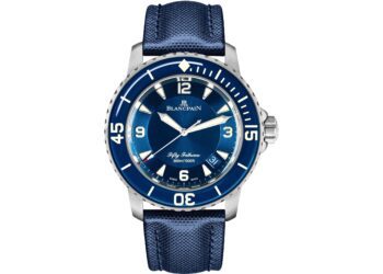 A Blancpain Fifty Fathoms dive watch with a blue dial, blue rotating bezel, and blue strap, displaying the time 10:10—an iconic choice among the best luxury watches.