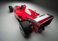 Red Formula 1 racing car with Shell and Marlboro branding, photographed in a studio setting from a rear-side angle, highlighting large rear tires. This historic Ferrari F2001 became the most valuable Schumacher-F1 car at the Monaco Sale, auctioned for €15.98 million.