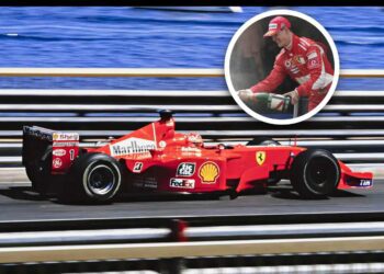 A red Ferrari Formula 1 car races on track near water; inset shows a driver celebrating with champagne—capturing the excitement of the Historic Monaco Sale, where the Ferrari F2001 became the most valuable Schumacher-F1 car at €15.98 million.