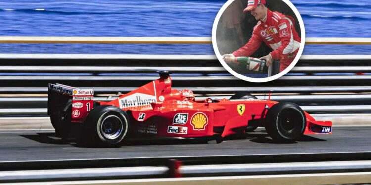 A red Ferrari Formula 1 car races on track near water; inset shows a driver celebrating with champagne—capturing the excitement of the Historic Monaco Sale, where the Ferrari F2001 became the most valuable Schumacher-F1 car at €15.98 million.