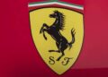 Yellow Ferrari logo with a black prancing horse, the letters "S" and "F," and an Italian flag stripe at the top on a red background, evokes the spirit of the Historic Monaco Sale: Ferrari F2001, Schumacher's most valuable F1 car auctioned at €15.98 million.