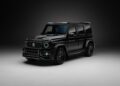 A black, modern luxury G-Wagon SUV with a sleek Aero Kit is parked in a dimly lit studio against a dark background.