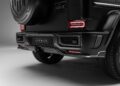Close-up view of the rear end of a black SUV with Urban branding, featuring LED tail lights, a visible spare tire cover, and Widetrack kits inspired by the iconic G-Wagon.