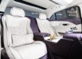The interior of a luxury car with white and purple leather seats, gold-colored details, and the "Galaxy Macau" logo on the headrests and rear console reflects the elegance found in bespoke sedans by Bentley Motors.