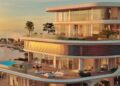 Modern multi-story beachfront building, part of Jacob & Co.’s announced $1.3B beachfront development south of Dubai, with large glass windows, spacious balconies, outdoor seating areas, lush greenery, and a swimming pool overlooking the ocean at sunset.