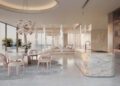 Modern open-plan kitchen and dining area with marble surfaces, pastel chairs, and pendant lighting. Neutral tones and natural light evoke the elegance of the Jacob & Co. Announces A $1.3B Beachfront Development South Of Dubai.