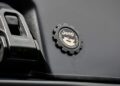 Close-up of a Jeep Performance badge and latch on a matte black interior—just one thing that makes this carbon-fiber tent a game changer for the Jeep Wrangler.