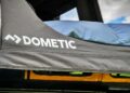 Close-up of a black Dometic-branded fabric rooftop tent—One Thing That Makes This Carbon-Fiber Tent A Game Changer For The Jeep Wrangler is its lightweight strength, with part of a blue sleeping pad visible inside.