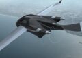 A sleek, black futuristic aircraft—resembling a production prototype of the Klein Vision AirCar—flies above a coastal landscape, with water and land visible below.